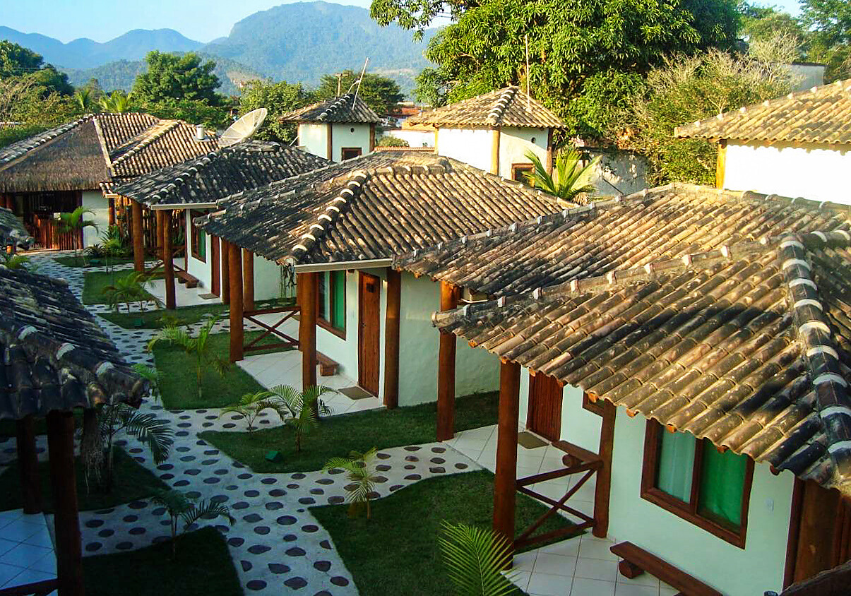 Vila de chalés com pilares de eucalipto roliço e telhado colonial